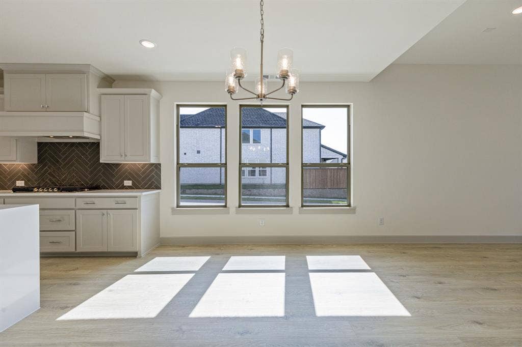 6901 Chief Spotted Tail Drive, McKinney, TX 75070 Whether it's lively dinner parties of cozy family gatherings, this dining are fits all occasions!