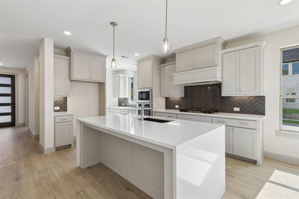 6901 Chief Spotted Tail Drive, McKinney, TX 75070 This beautifully finished Juliet floor plan features a dream kitchen filled with tons of storage and prep space!