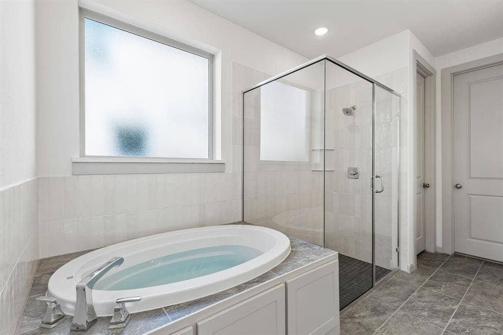 6901 Chief Spotted Tail Drive, McKinney, TX 75070 Your new owner's bath comes complete with a relaxing garden tub and oversized, walk in shower.
