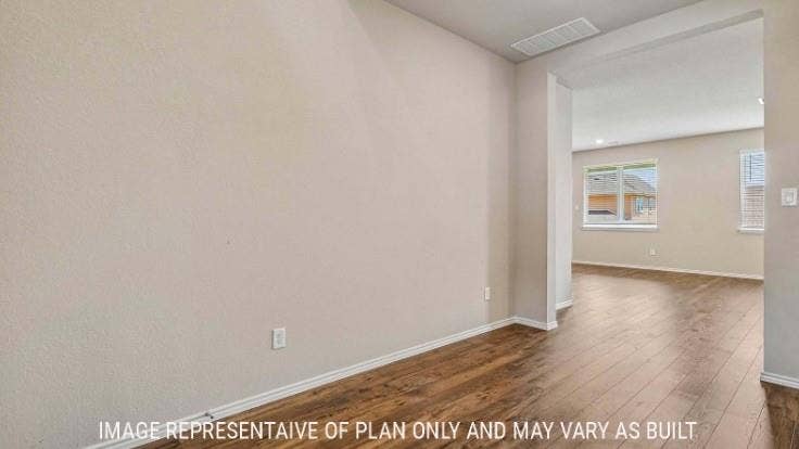 Wood-finish flooring throughout, light neutral wall paint, and white trim