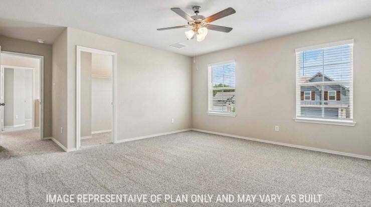 Carpeted room with a ceiling fan, two windows with blinds, and neutral wall tones