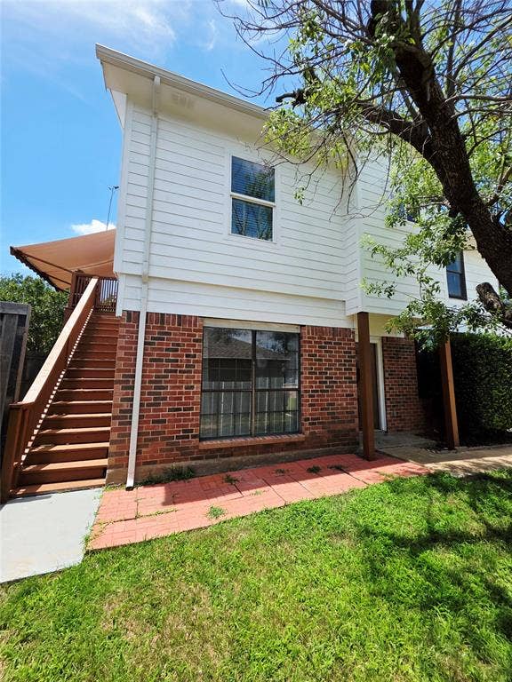 3009 Plumtree Lane, Plano, TX 75074 Multi-story exterior with white horizontal siding and brick accents