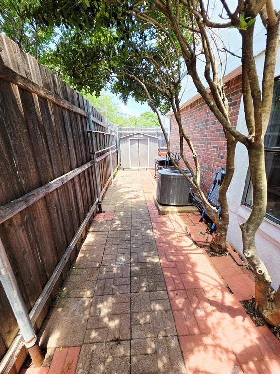 3009 Plumtree Lane, Plano, TX 75074 Paved walkway with a wood fence and brick exterior