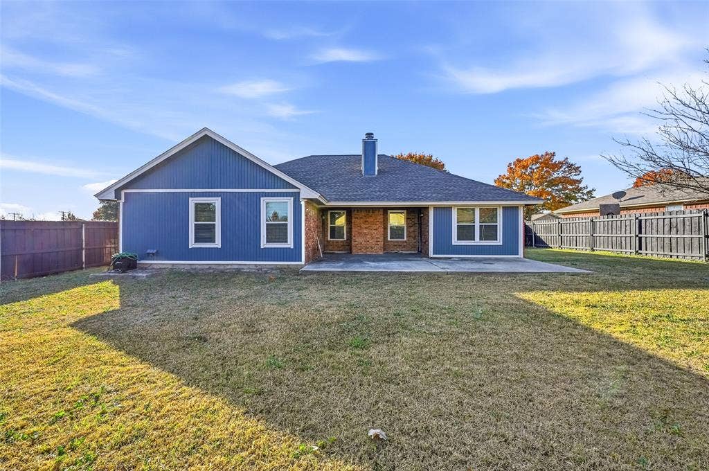 6421 Fairview Drive, Watauga, TX 76148 Expansive backyard featuring a concrete patio, wood privacy fencing, and a brick and siding exterior