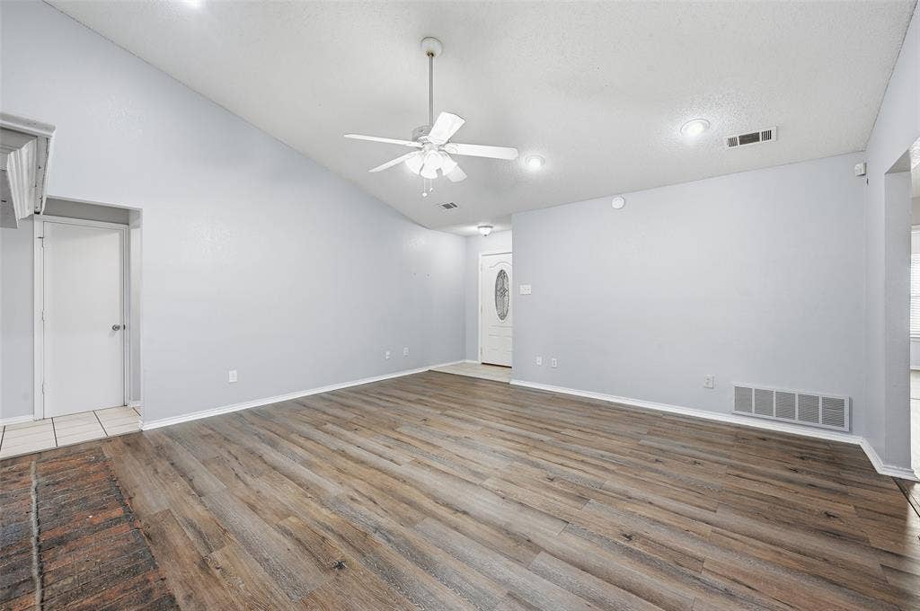 6421 Fairview Drive, Watauga, TX 76148 Vaulted ceiling, wood-finish flooring, ceiling fan, recessed lighting, and a front entry door with an oval glass insert