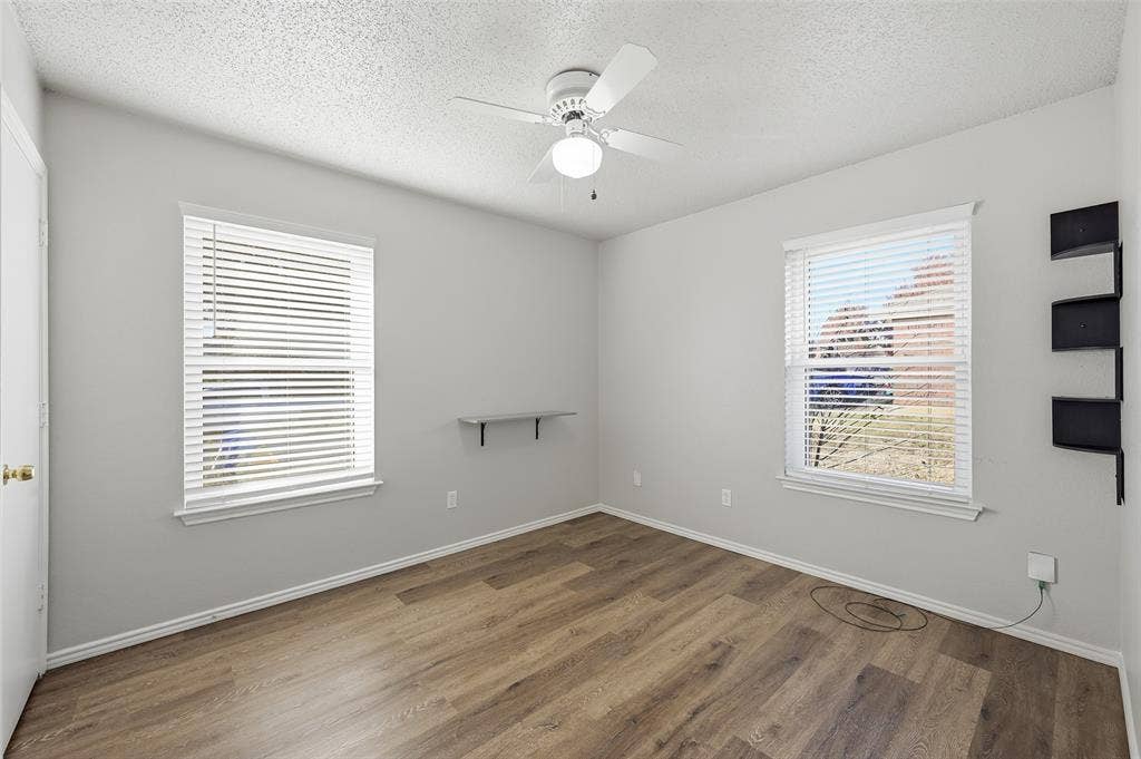 6421 Fairview Drive, Watauga, TX 76148 Wood-finish flooring with white baseboards