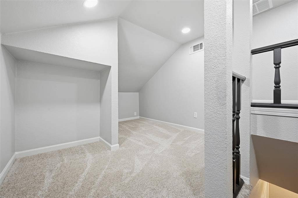 6421 Fairview Drive, Watauga, TX 76148 Carpeted upper level with recessed lighting and sloped ceilings