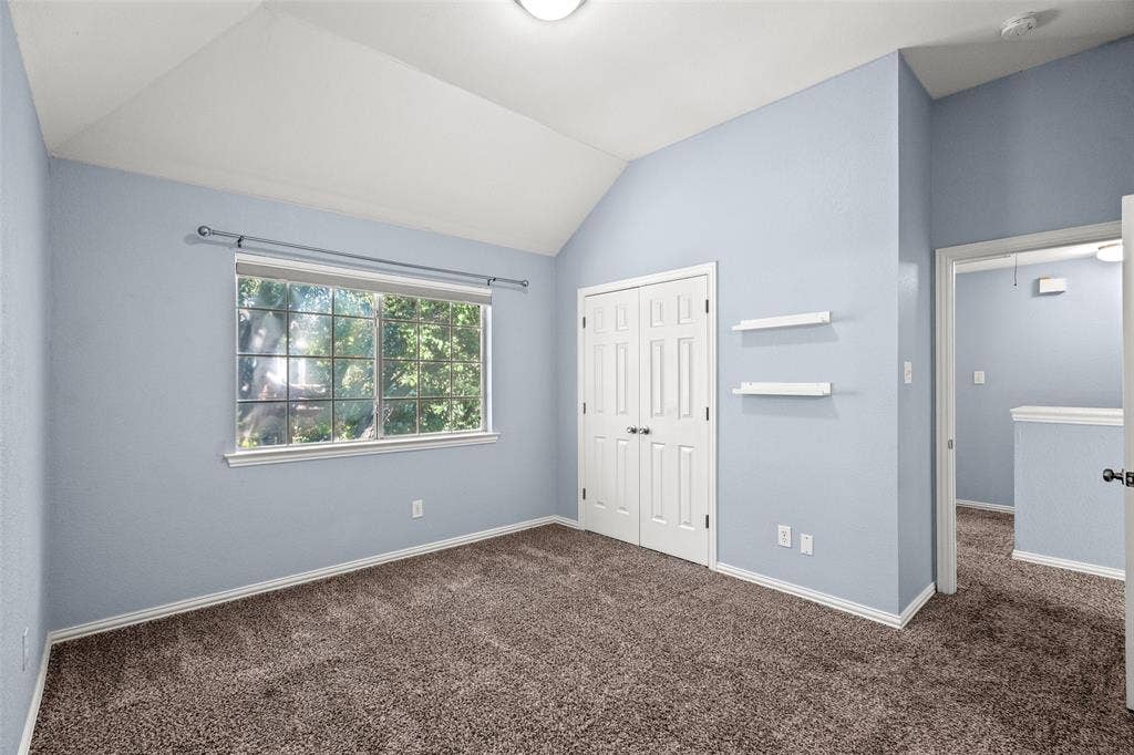 14592 Aspen Court, Addison, TX 75001 Vaulted ceiling, carpeted flooring, double-door closet, built-in shelving, and transom window