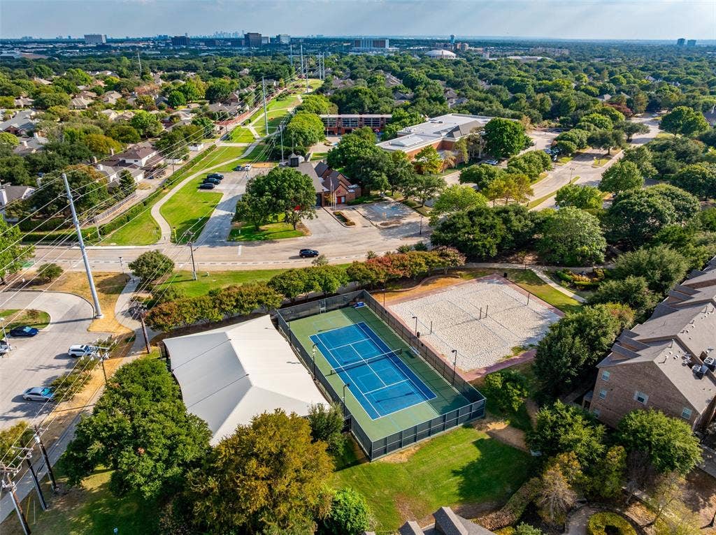 14592 Aspen Court, Addison, TX 75001 Aerial perspective showcasing a tennis court, sand volleyball court, and adjacent covered structure