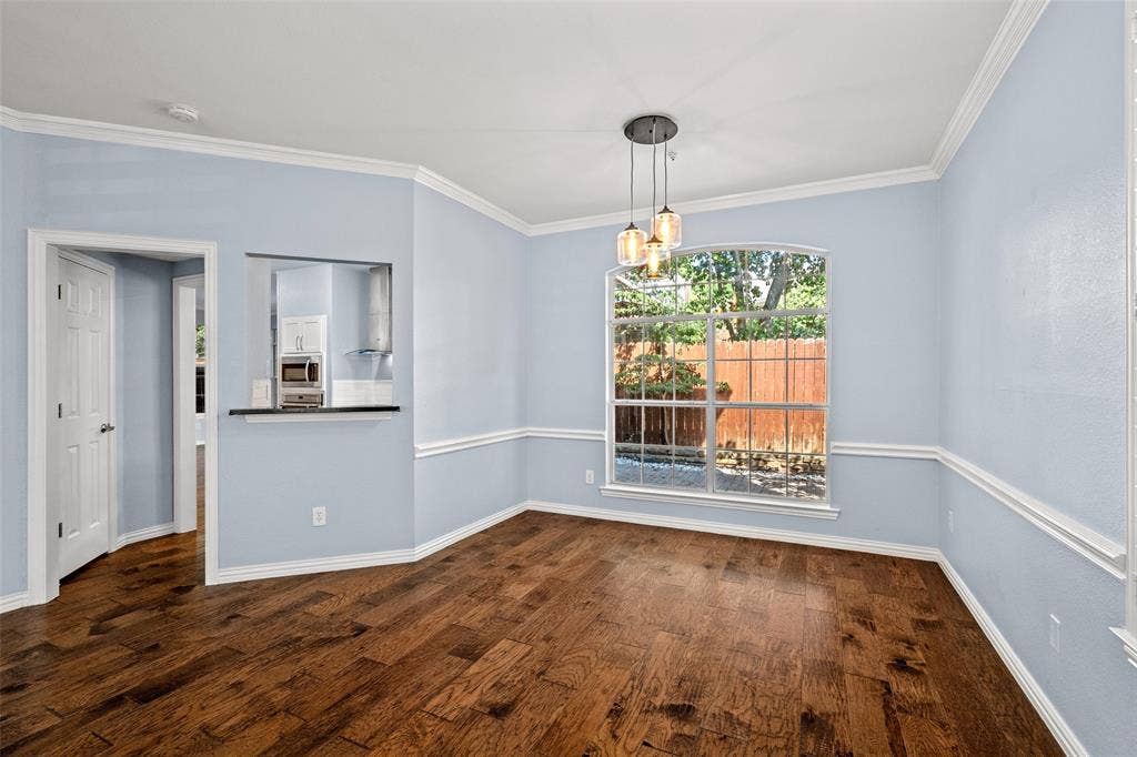 14592 Aspen Court, Addison, TX 75001 Wood-finish flooring with crown molding and chair rail accents