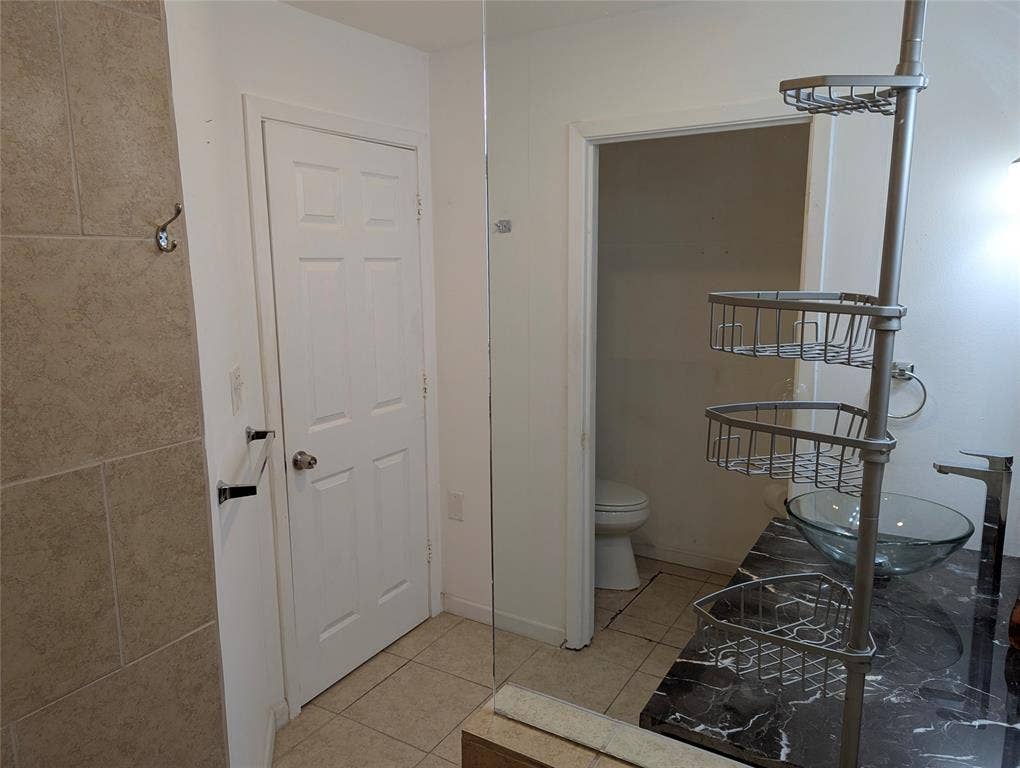111 Murchison Street, Farmersville, TX 75442 View 3: Additional view of the primary ensuite featuring built-in shelving for towels, toiletries, and extra storage.