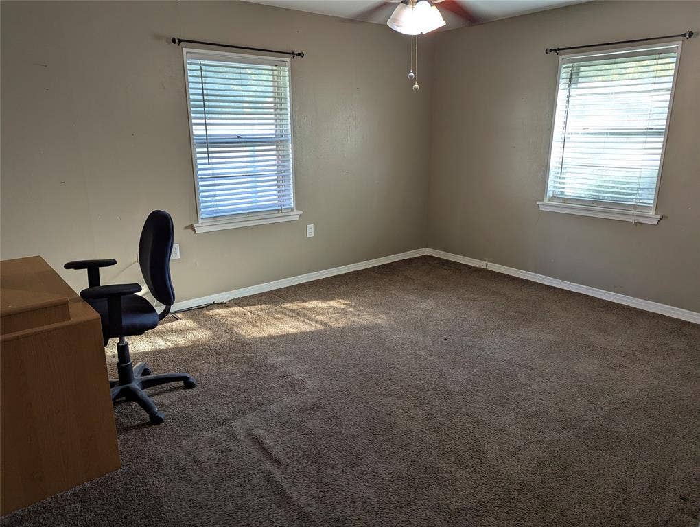 111 Murchison Street, Farmersville, TX 75442 Bedroom#2 Spacious secondary bedroom located in the northeast corner of the home, featuring two windows for natural light, carpeted flooring, and a ceiling fan.