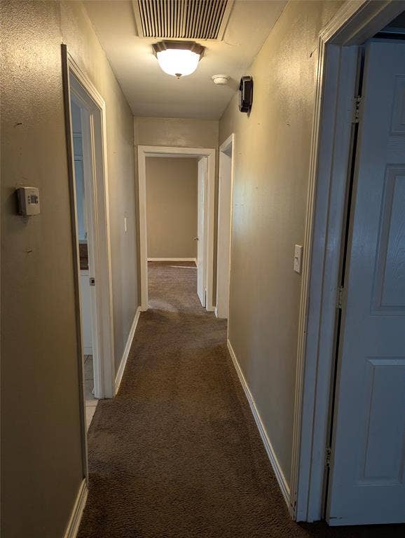 111 Murchison Street, Farmersville, TX 75442 Hallway located on the east side of the living area provides access to all three bedrooms and the full hallway bathroom, with an additional storage closet at the end of the hall.