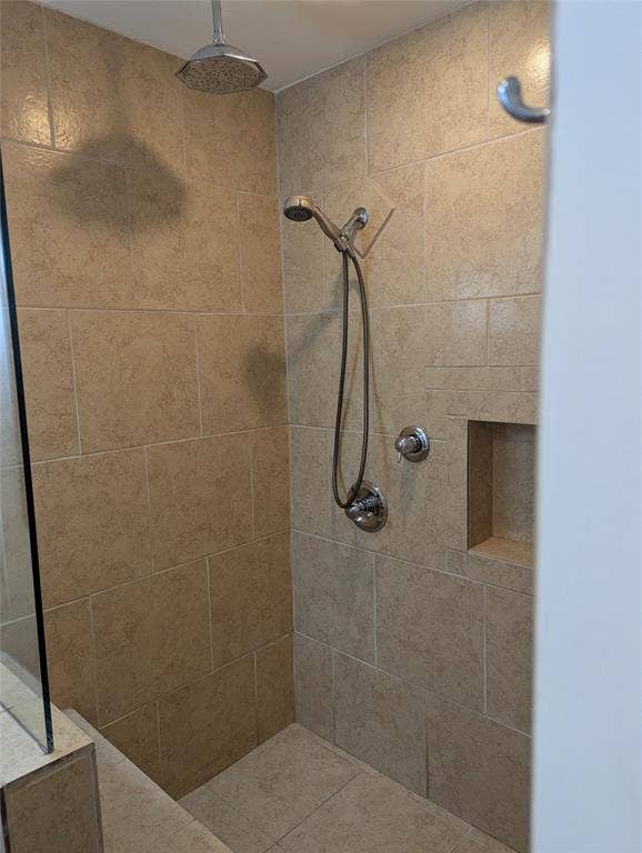 111 Murchison Street, Farmersville, TX 75442 View 2: Tiled walk-in shower with built-in bench, handheld showerhead, and convenient grab bars.