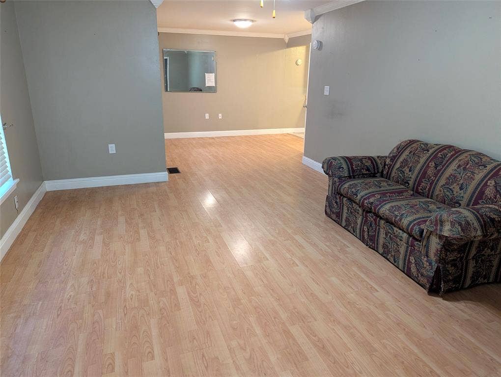 111 Murchison Street, Farmersville, TX 75442 Generously sized living area with wood-look flooring, neutral tones, and flexible space to make your own.