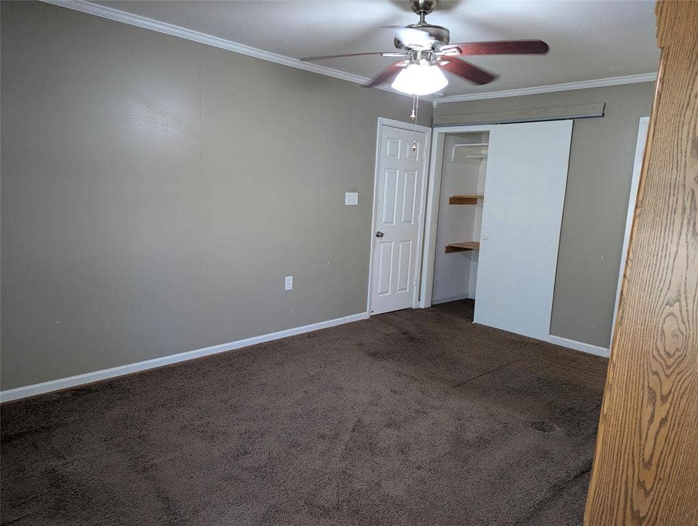 111 Murchison Street, Farmersville, TX 75442 View 2: Another view of the primary suite, highlighting built-in shelving and convenient access to additional storage.