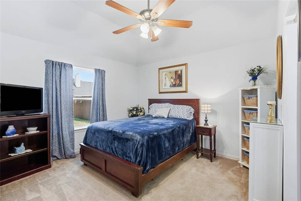 1926 Vintage Drive, Corinth, TX 76210 Ceiling fan with light fixture, window with backyard visibility, wall-to-wall carpeting, and white painted walls