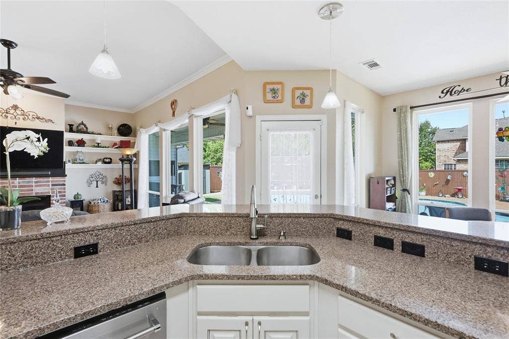 1926 Vintage Drive, Corinth, TX 76210 Kitchen featuring a double basin stainless steel sink, light-toned countertops, white cabinetry, and stainless steel appliances