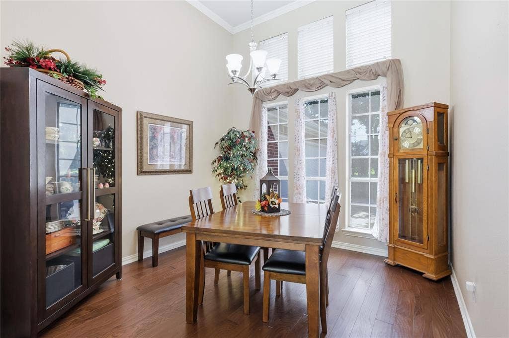 1926 Vintage Drive, Corinth, TX 76210 Vaulted ceiling with a chandelier, wood-finish flooring, and multiple tall windows