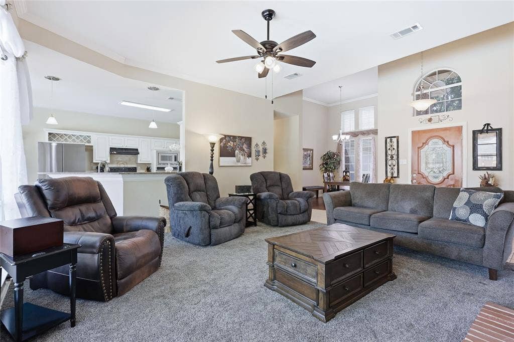 1926 Vintage Drive, Corinth, TX 76210 Living area with vaulted ceilings, ceiling fan, and arched window