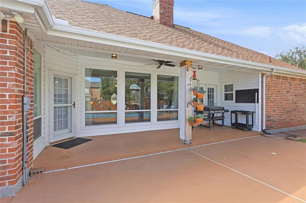 1926 Vintage Drive, Corinth, TX 76210 Covered patio with a ceiling fan, exterior lighting, and brick accents