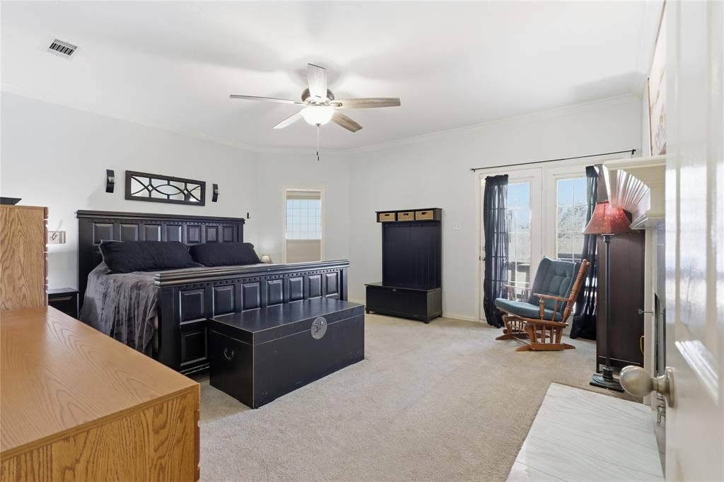 1926 Vintage Drive, Corinth, TX 76210 Recessed lighting, ceiling fan, neutral carpet, crown molding, and double French doors with transom windows