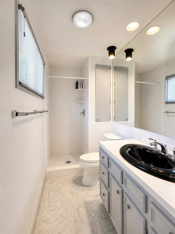 3401 Hanover Lane, Irving, TX 75062 Vanity with a black oval sink, chrome faucet, and gray cabinetry