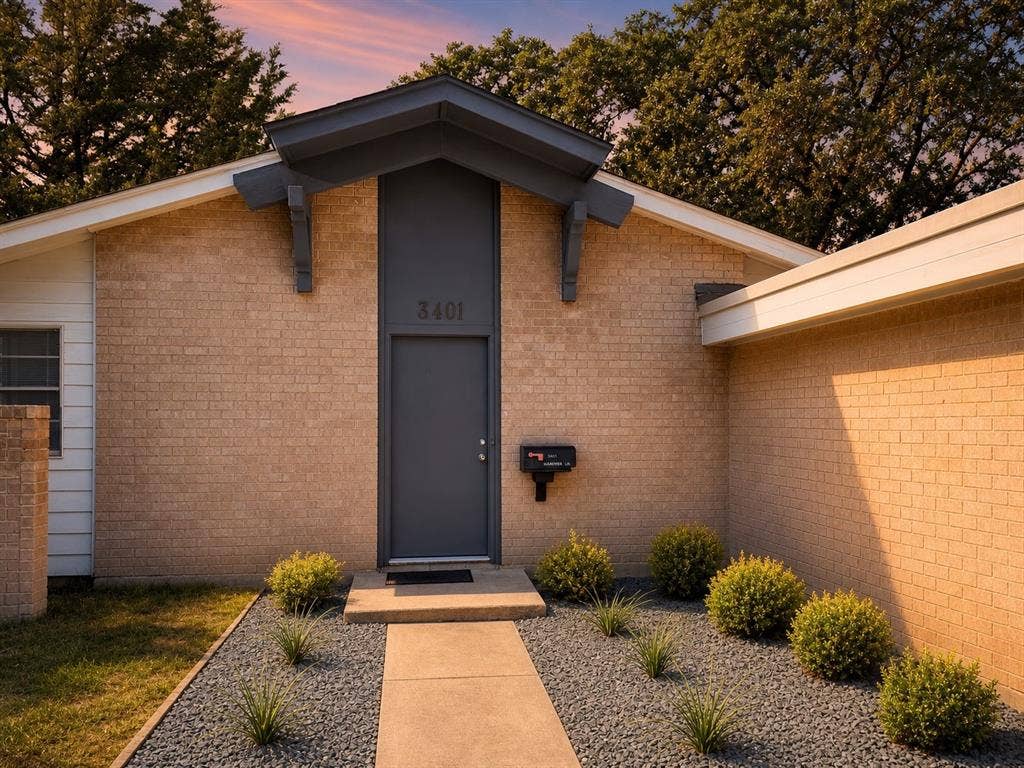 3401 Hanover Lane, Irving, TX 75062 Brick exterior with a contemporary gray entry door