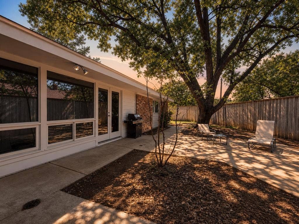 3401 Hanover Lane, Irving, TX 75062 Expansive concrete patio with direct access to interior spaces through French doors