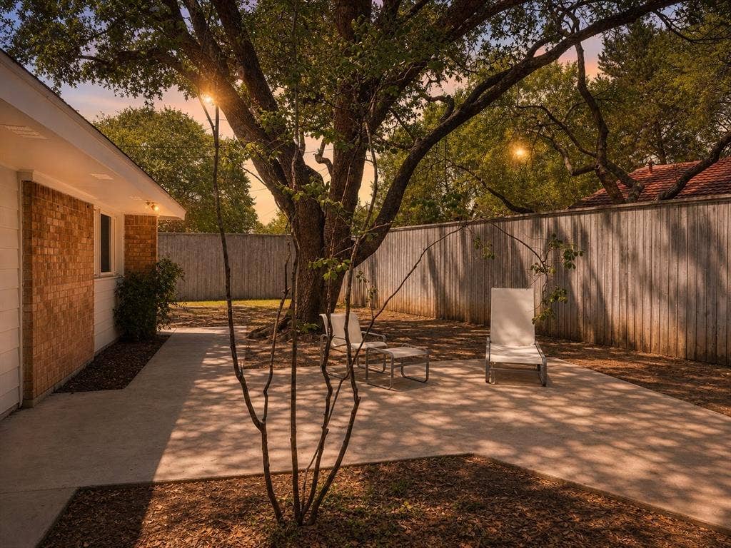 3401 Hanover Lane, Irving, TX 75062 Exterior featuring a brick facade, white siding, and built-in lighting