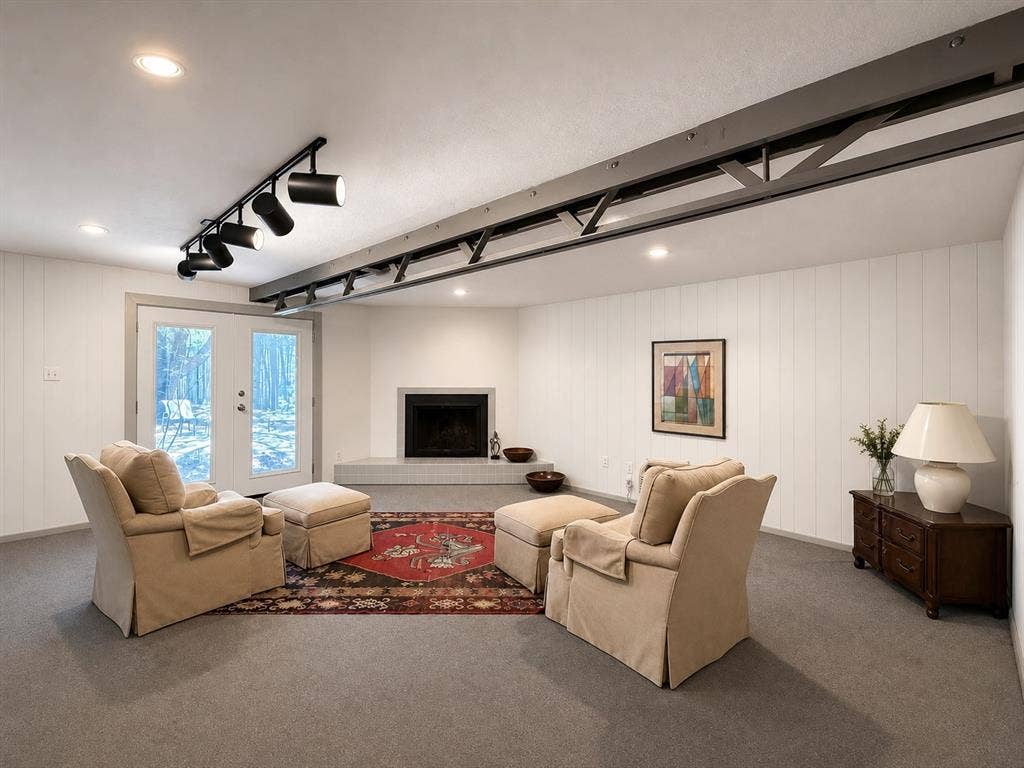 3401 Hanover Lane, Irving, TX 75062 Recessed lighting, exposed structural beam, white paneled walls, built-in fireplace with hearth, and exterior french doors