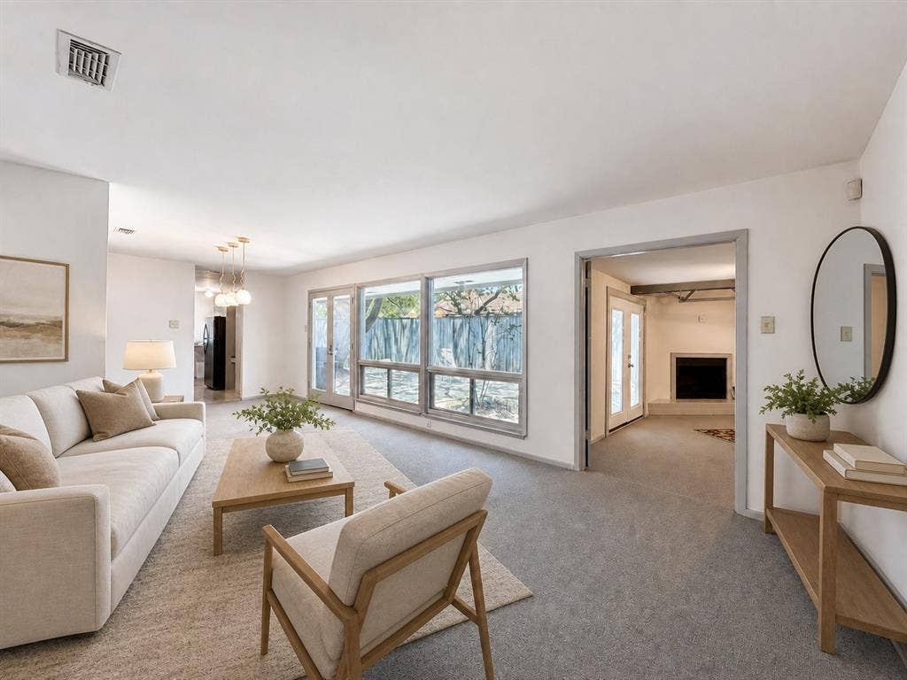 3401 Hanover Lane, Irving, TX 75062 Living space with large windows, light gray carpeting, and a built-in fireplace