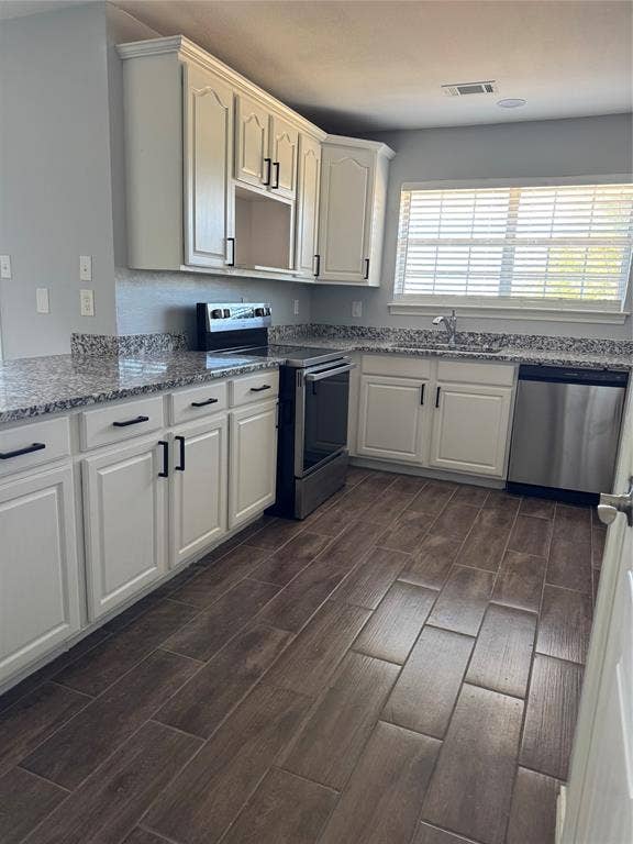 109 Waldman Drive, Gun Barrel City, TX 75156 Kitchen featuring white cabinetry, stainless steel appliances
