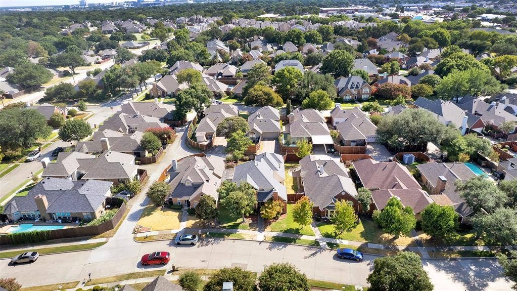1920 Keystone Drive, Plano, TX 75075 Aerial perspective of a residential neighborhood with mature trees, established homes, and paved streets