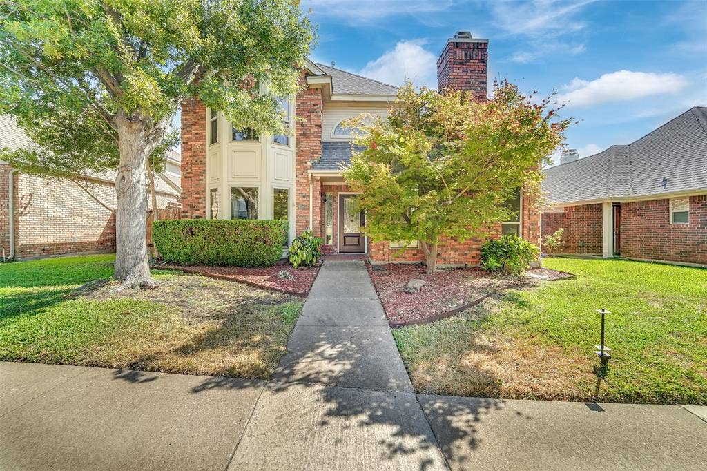 1920 Keystone Drive, Plano, TX 75075 Brick exterior with a prominent bay window, mature trees, and a well-defined walkway