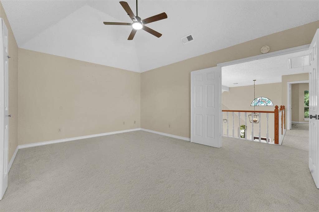 1920 Keystone Drive, Plano, TX 75075 Vaulted ceiling with a ceiling fan, neutral wall color, and light-toned carpeting