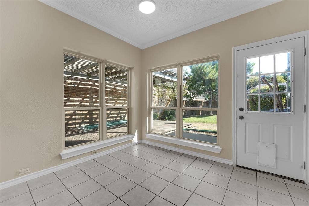 1920 Keystone Drive, Plano, TX 75075 White tile flooring, multiple large windows, recessed lighting, and a white paneled door with glass inserts