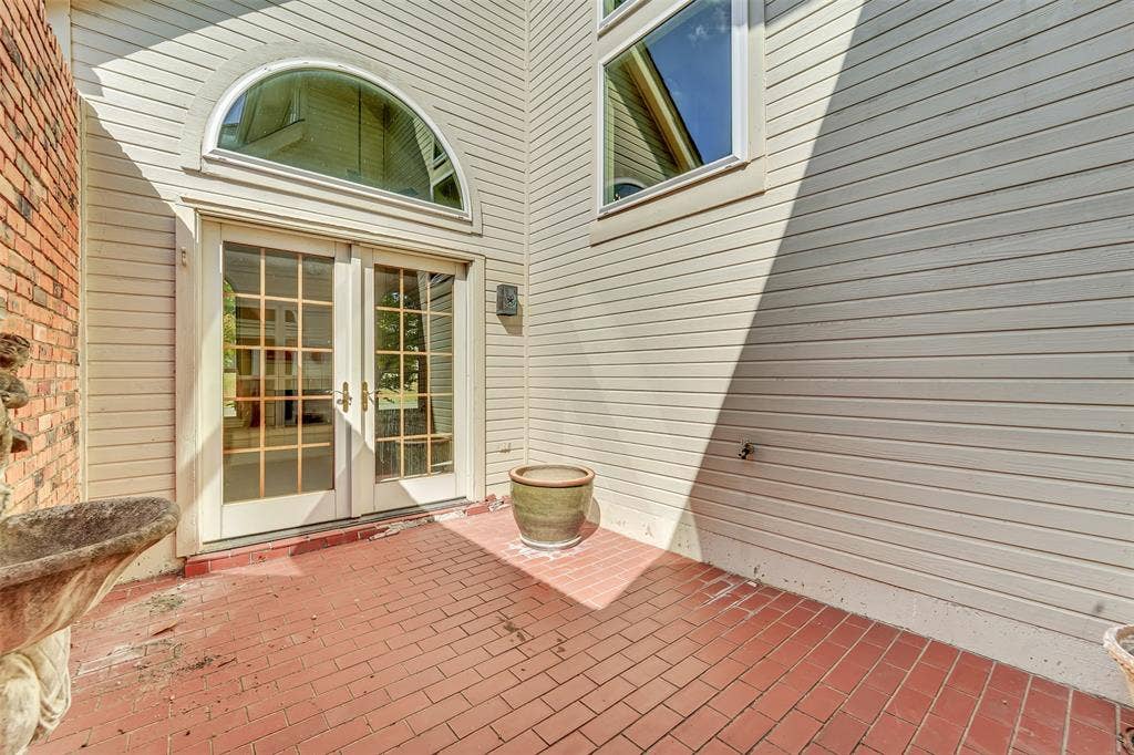 1920 Keystone Drive, Plano, TX 75075 Brick patio with double French doors, transom window, and siding exterior