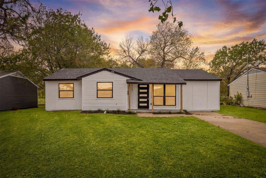 565 alcorn Avenue, Dallas, TX 75217 White exterior with dark trim, black shingle roof, and a contemporary front entry door with vertical glass inserts