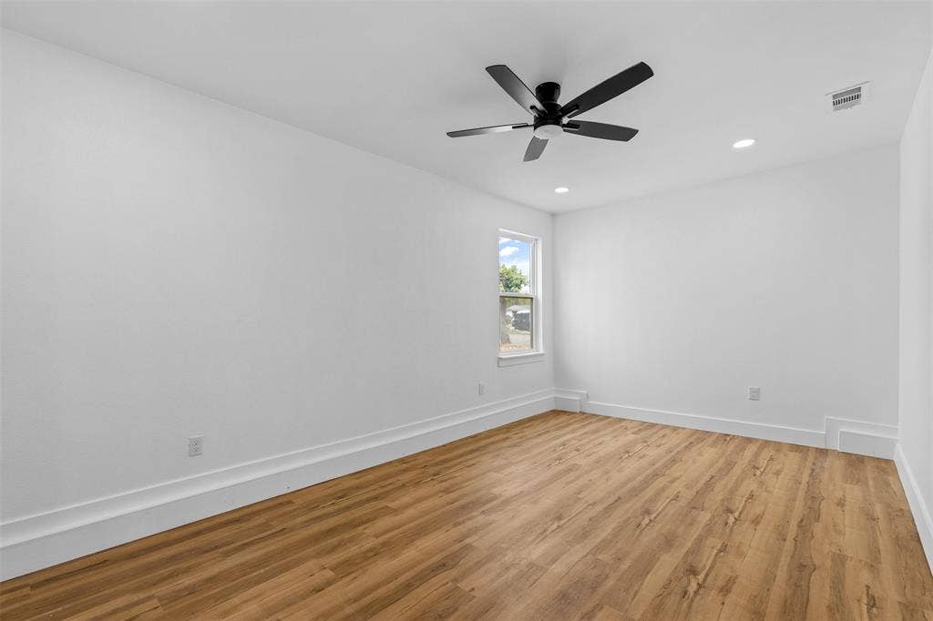 565 alcorn Avenue, Dallas, TX 75217 Wood-finish flooring, white walls, and a single window