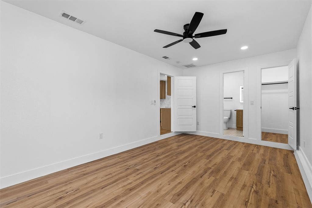 565 alcorn Avenue, Dallas, TX 75217 Wood-finish flooring throughout, white walls, recessed lighting, and a black ceiling fan