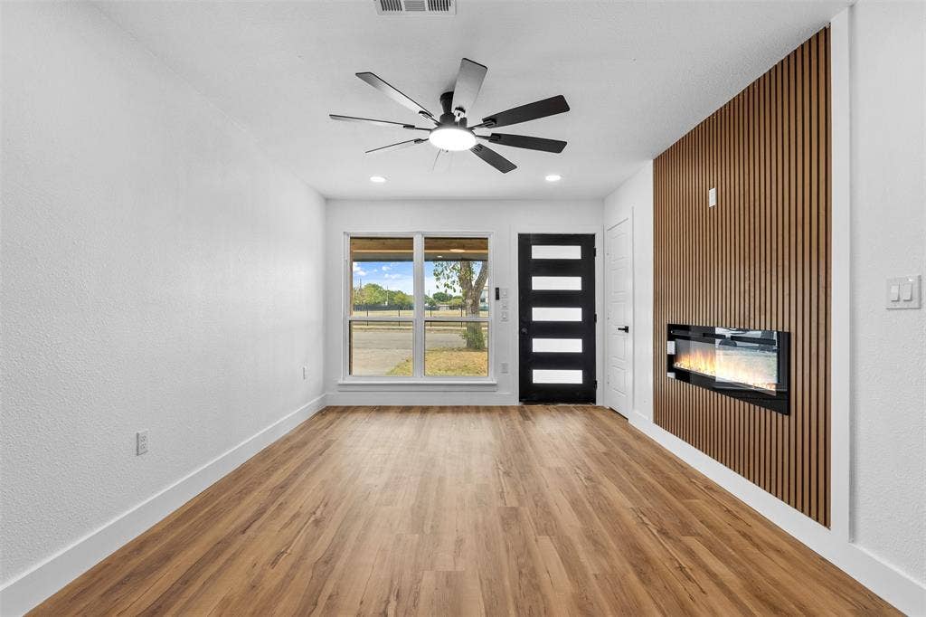 565 alcorn Avenue, Dallas, TX 75217 Wood-finish flooring, white walls, and a modern ceiling fan with lighting