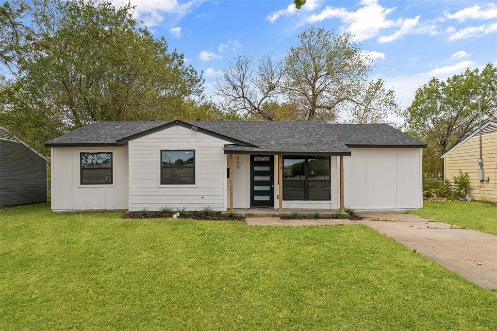 565 alcorn Avenue, Dallas, TX 75217 Modern exterior with white siding, black trim windows, a dark shingle roof, and a contemporary front door with vertical glass panels