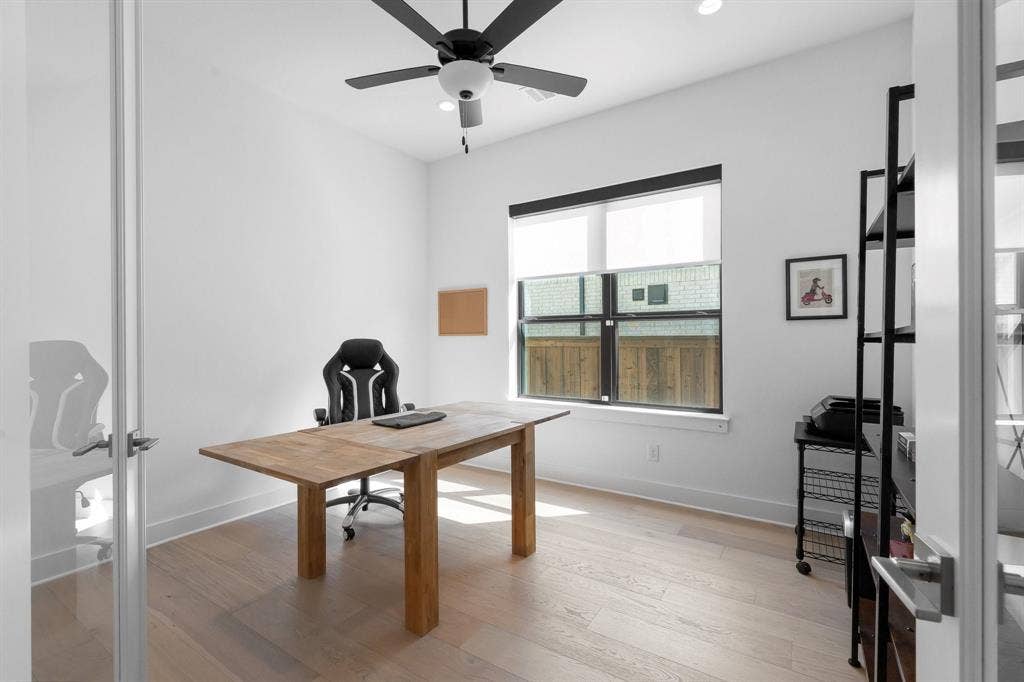 Recessed lighting, wood-finish flooring, ceiling fan, and a large window with roller shades