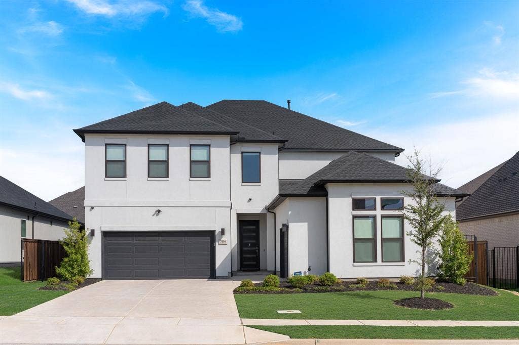 Modern two-story stucco exterior with a dark shingle roof