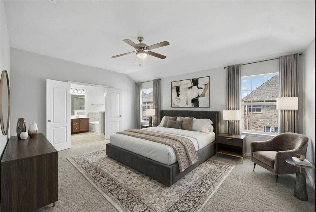 2309 Shingle Lane, Plano, TX 75074 Vaulted ceiling with ceiling fan, dual windows with curtain rods, and interior double doors opening to a bathroom