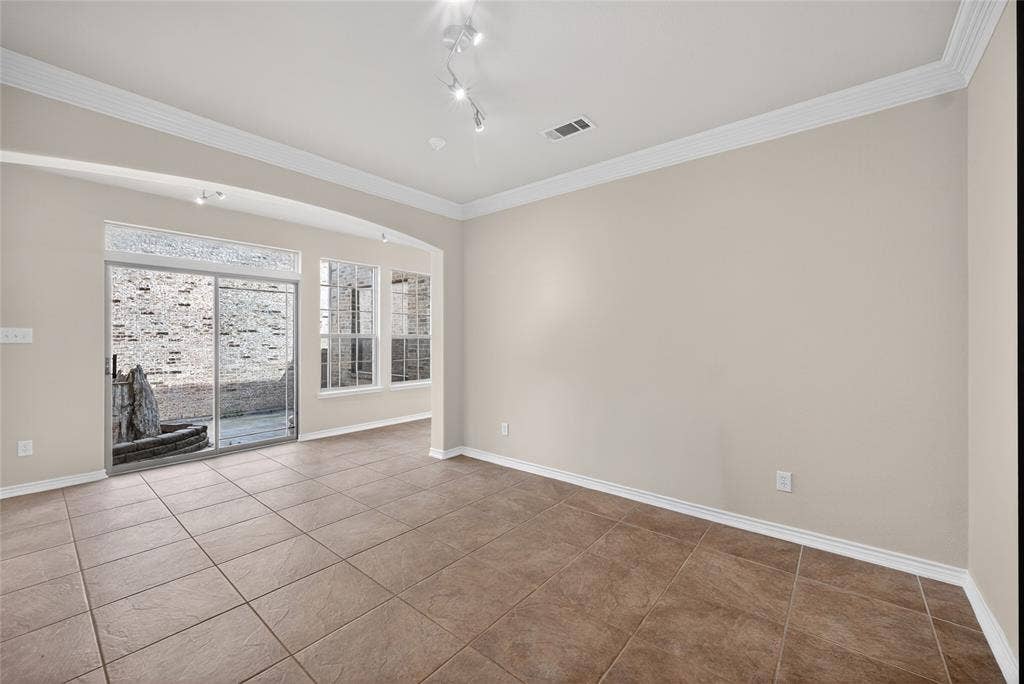 2309 Shingle Lane, Plano, TX 75074 Tile flooring, crown molding, arched entryways, sliding glass patio door, and recessed lighting
