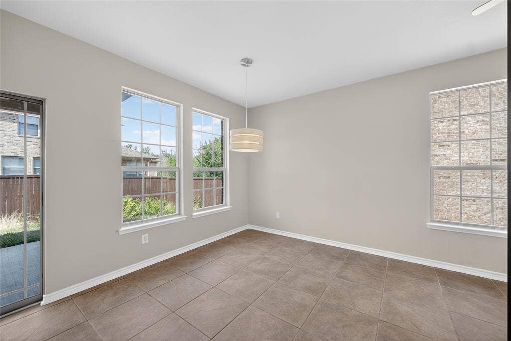 2309 Shingle Lane, Plano, TX 75074 Tile flooring, multiple windows, a sliding glass door, and a drum pendant light fixture