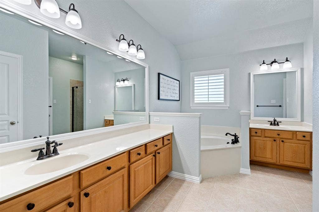 11701 Cambria Court, Fort Worth, TX 76008 Dual vanities with undermount sinks, wood cabinetry, and extensive countertop space