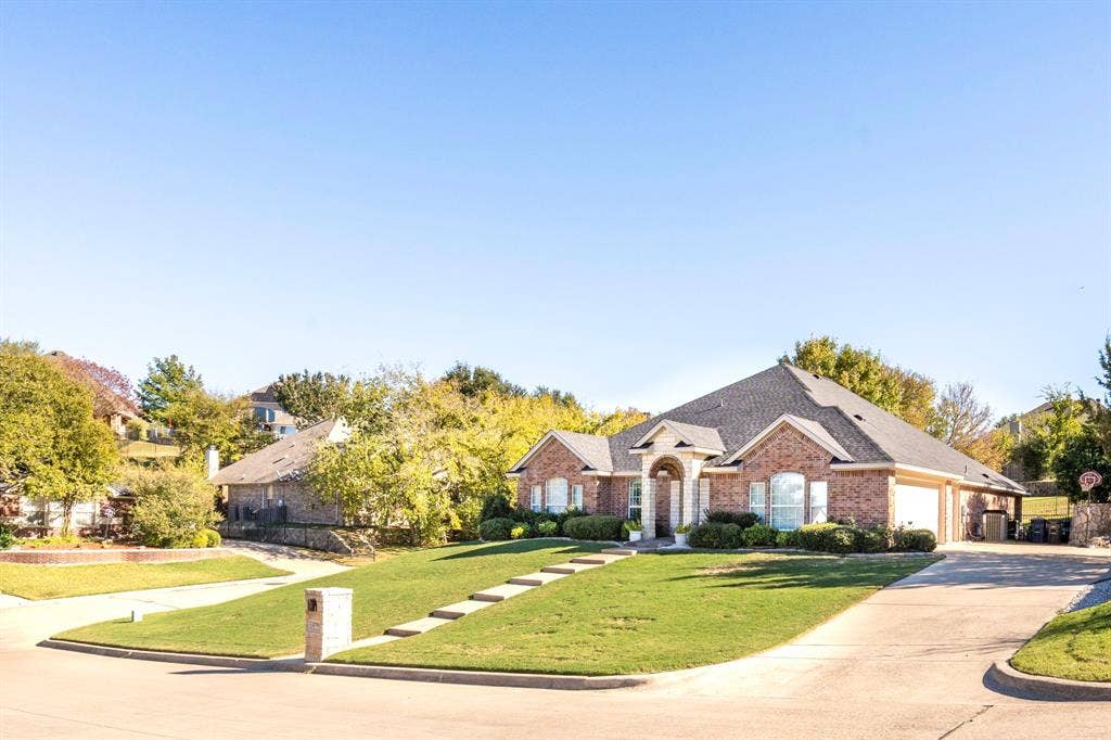 11701 Cambria Court, Fort Worth, TX 76008 Brick exterior with a gabled roof and arched entryway